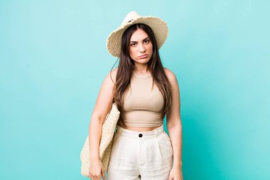 young pretty woman feeling sad and whiney with an unhappy look and crying. summer and hat concept