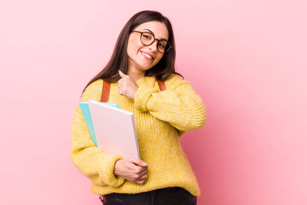 young pretty woman feeling happy and facing a challenge or celebrating. university student concept