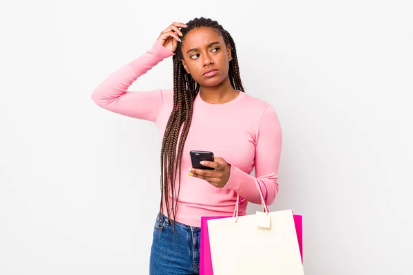 Young Adult Black Woman Feeling Puzzled Confused Scratching Head Shopping — Stockfoto