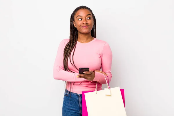 Young Adult Black Woman Shrugging Feeling Confused Uncertain Shopping Bags — Stockfoto