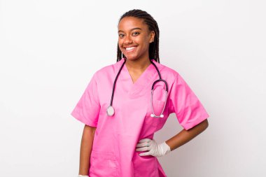 young adult black woman smiling happily with a hand on hip and confident. veterinarian concept
