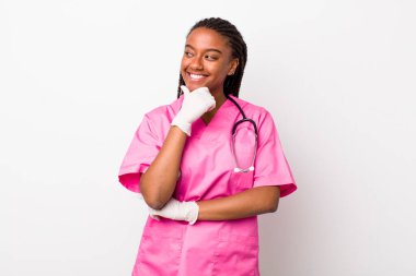 young adult black woman smiling with a happy, confident expression with hand on chin. veterinarian concept