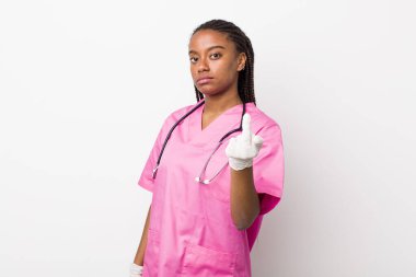 young adult black woman feeling angry, annoyed, rebellious and aggressive. veterinarian concept