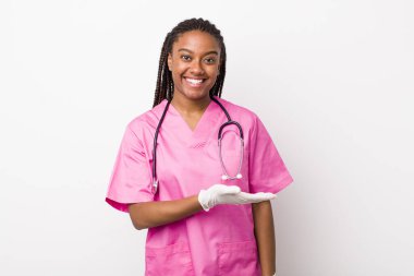 young adult black woman smiling cheerfully, feeling happy and showing a concept. veterinarian concept