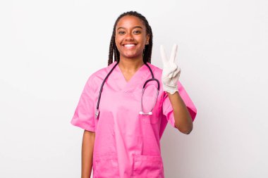 young adult black woman smiling and looking friendly, showing number two. veterinarian concept