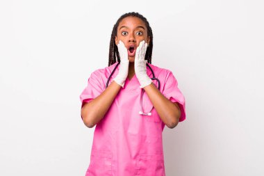 young adult black woman feeling shocked and scared. veterinarian concept
