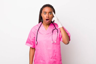 young adult black woman looking surprised, realizing a new thought, idea or concept. veterinarian concept