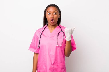 young adult black woman looking astonished in disbelief. veterinarian concept
