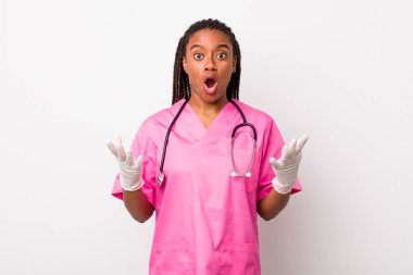 young adult black woman amazed, shocked and astonished with an unbelievable surprise. veterinarian concept