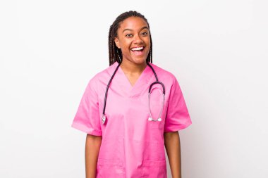 young adult black woman looking happy and pleasantly surprised. veterinarian concept