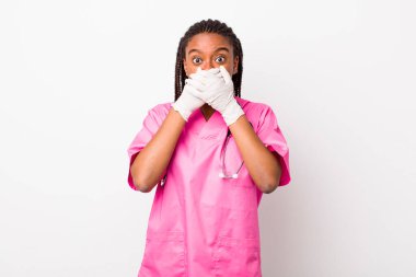 young adult black woman covering mouth with hands with a shocked. veterinarian concept