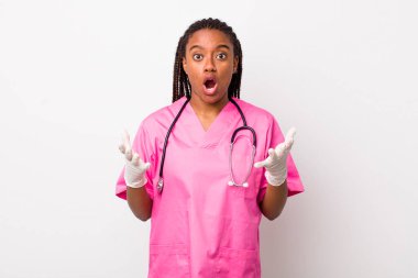 young adult black woman feeling extremely shocked and surprised. veterinarian concept