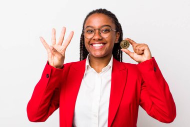young adult black woman smiling and looking friendly, showing number four. crypto coin concept