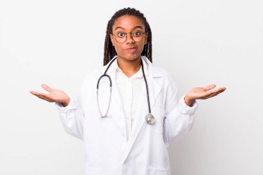 young adult black woman feeling puzzled and confused and doubting. physician concept