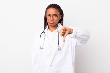young adult black woman feeling cross,showing thumbs down. physician concept