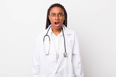 young adult black woman looking very shocked or surprised. physician concept