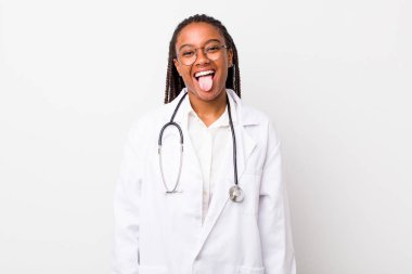 young adult black woman with cheerful and rebellious attitude, joking and sticking tongue out. physician concept