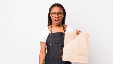 young adult black woman looking very shocked or surprised. take away delivery concept