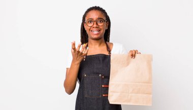 young adult black woman looking desperate, frustrated and stressed. take away delivery concept