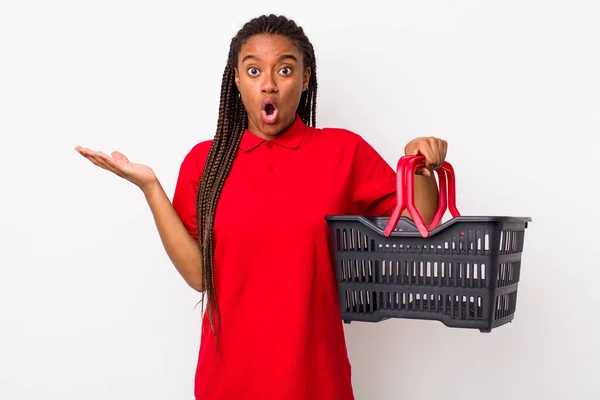 Young Adult Black Woman Looking Surprised Shocked Jaw Dropped Holding — Stok fotoğraf