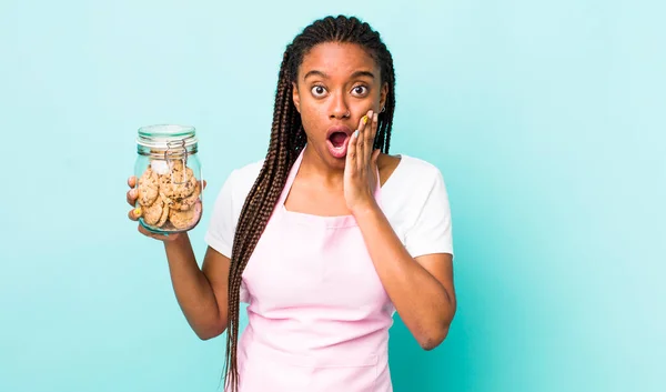 Young Adult Black Woman Feeling Shocked Scared Home Made Cookies — Zdjęcie stockowe