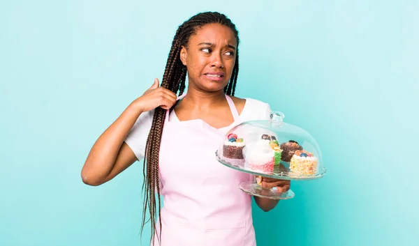 young adult black woman feeling stressed, anxious, tired and frustrated. home made cakes concept