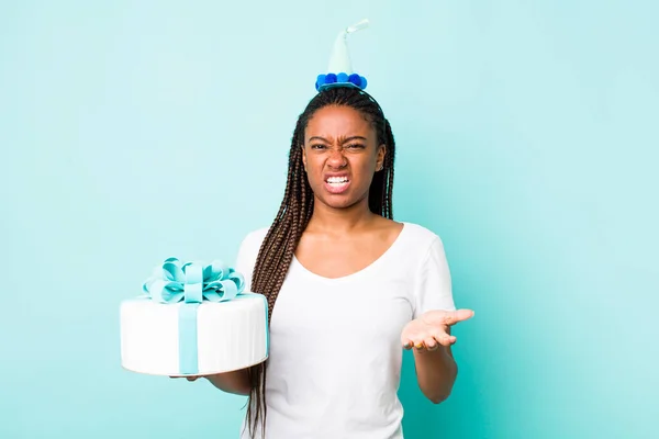 young adult black woman looking angry, annoyed and frustrated. birthday concept