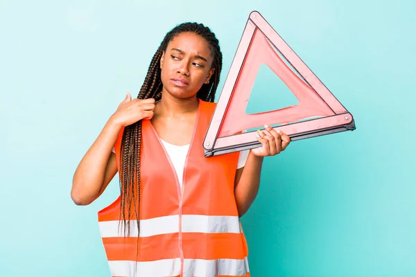 young adult black woman feeling stressed, anxious, tired and frustrated. car emergency triangle concept