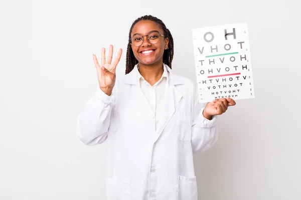 Young Adult Black Woman Smiling Looking Friendly Showing Number Four — Stockfoto