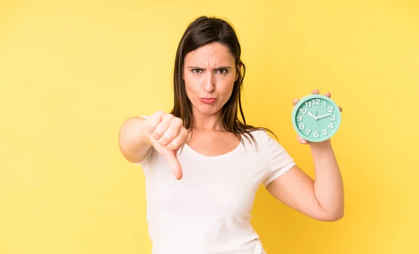 Young Adult Pretty Woman Feeling Cross Showing Thumbs Alarm Clock — Foto de Stock