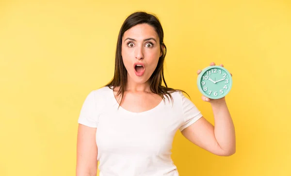 Young Adult Pretty Woman Looking Very Shocked Surprised Alarm Clock — Foto de Stock