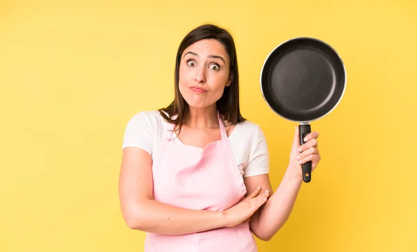 Young Adult Pretty Woman Shrugging Feeling Confused Uncertain Cooking Home — Stockfoto