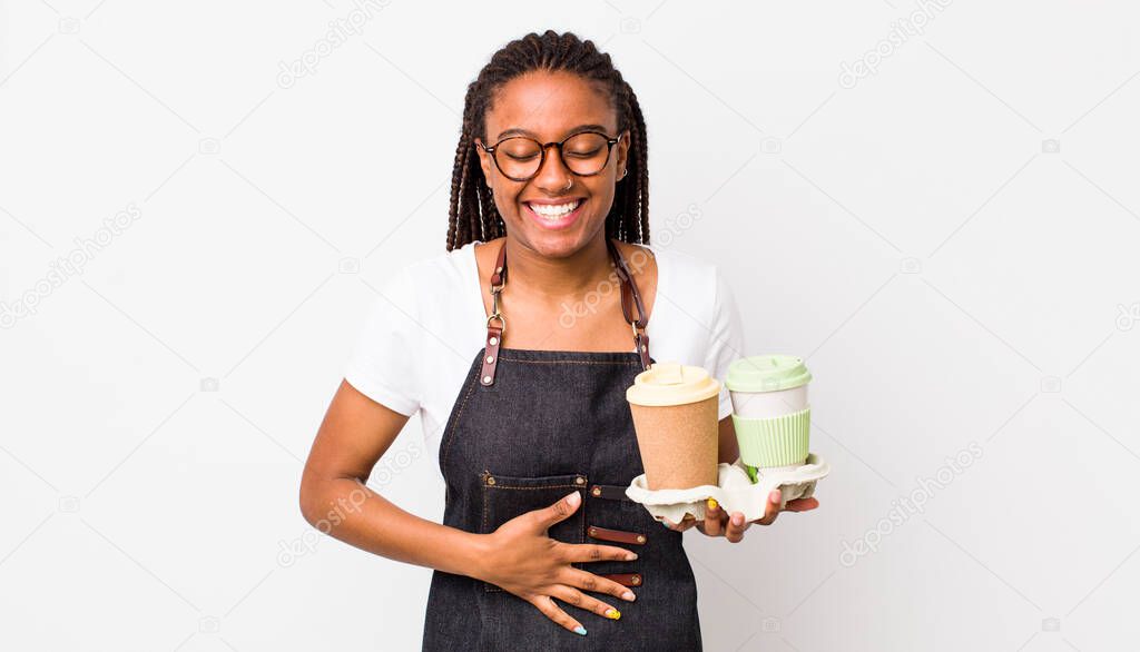 young adult black woman laughing out loud at some hilarious joke. take away coffees concept
