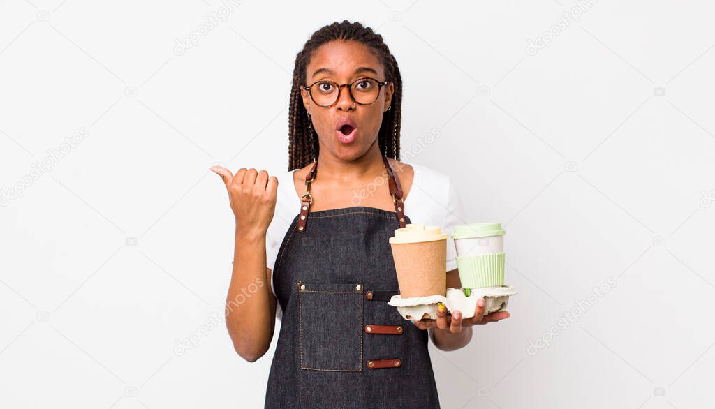 young adult black woman looking astonished in disbelief. take away coffees concept