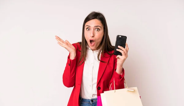 Young Adult Pretty Woman Looking Surprised Shocked Jaw Dropped Holding — Stockfoto