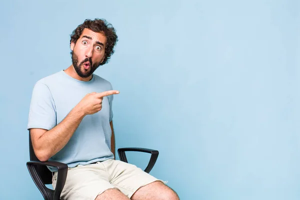 Young Adult Hispanic Crazy Man Sitting Chair Copy Space Concept — Stock Photo, Image