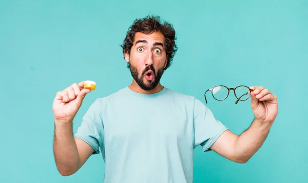 Young Adult Hispanic Crazy Man Choosing Glasses Contact Lens — Stock Photo, Image