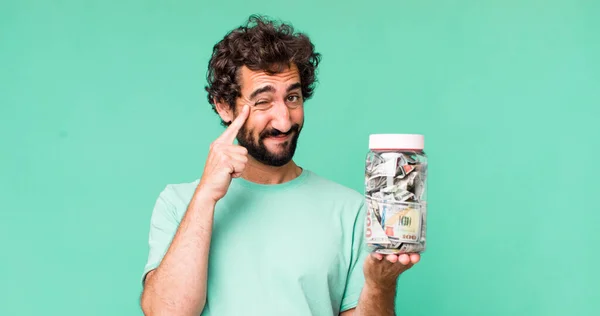 Young Adult Hispanic Crazy Man Savings Bottle Concept — Stock Photo, Image
