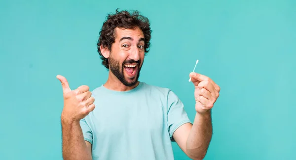 Young Adult Hispanic Crazy Man Using Ear Swab — Stock Photo, Image