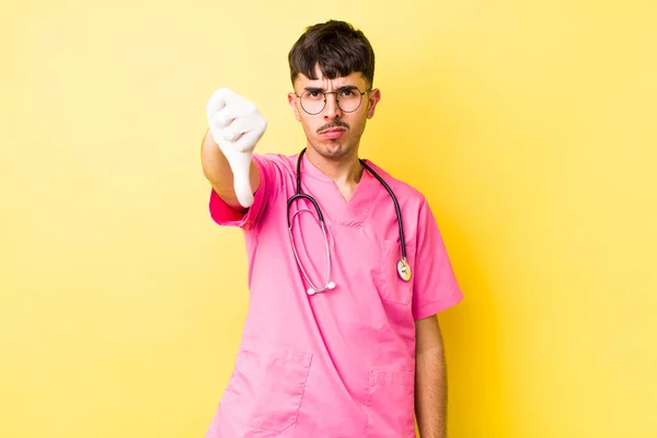 Young Hispanic Man Feeling Cross Showing Thumbs Veterinarian Concept — Stock Photo, Image