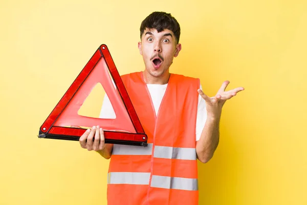 Young Hispanic Man Feeling Extremely Shocked Surprised Emergency Car Triangle — Stock Photo, Image