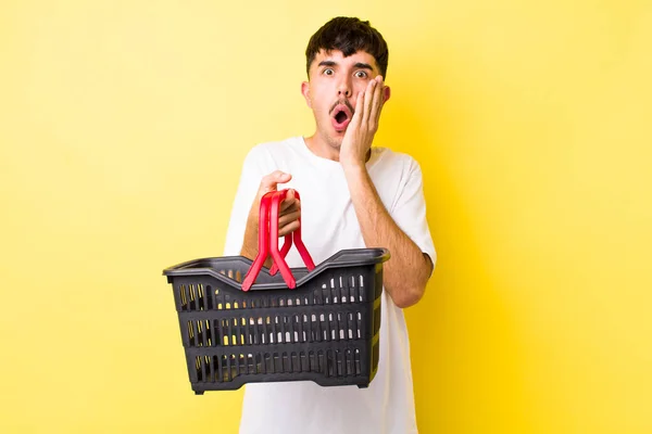 Young Hispanic Man Feeling Shocked Scared Empty Shopping Basket Concept — Stock Photo, Image