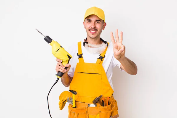 Hispanic Handyman Smiling Looking Friendly Showing Number Three Drill Concept — Stock Photo, Image