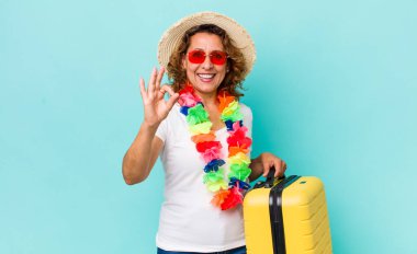 Orta yaşlı bir kadın kendini mutlu hissediyor, iyi bir jestle onaylıyor. Yaz tatili konsepti