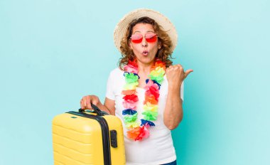 Orta yaşlı kadın inançsızlıktan şaşkın şaşkın bakıyor. Yaz tatili konsepti