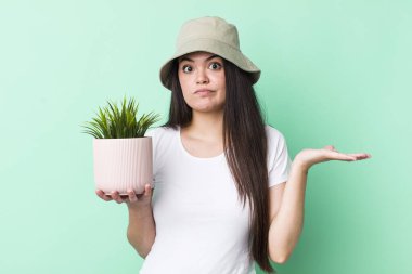 Genç bir kadın şaşkın, şaşkın ve şüpheci hissediyor. bitki kavramı