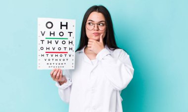 Genç yetişkin kadın düşünüyor, kuşkulu ve şaşkın hissediyor. optik görüş testi konsepti