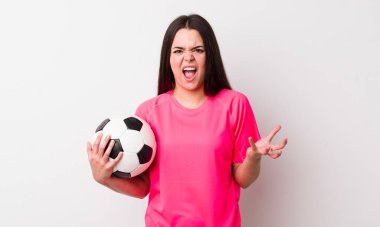 Genç bir kadın sinirli, sinirli ve sinirli görünüyor. futbol kavramı