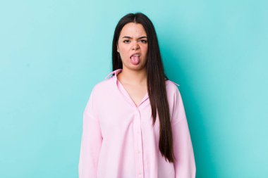 Genç bir kadın tiksinmiş ve rahatsız olmuş hissediyor. Dilini dışarı çıkarıyor. Çirkin ve iğrenç bir şeyden hoşlanmıyor.