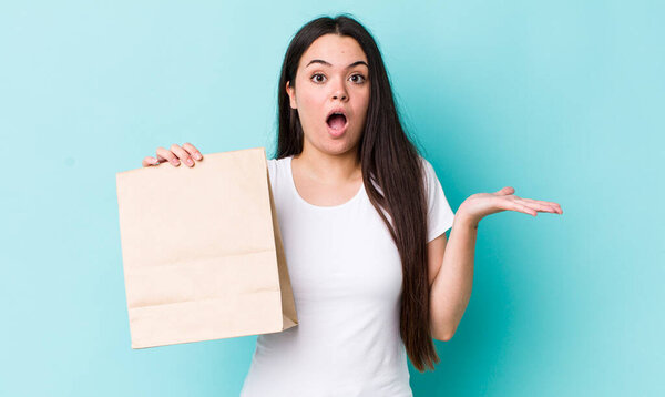 young adult woman amazed, shocked and astonished with an unbelievable surprise. take away concept